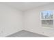 Bedroom with carpet floors, a large window, and white walls with neutral color at 4732 Babys Breath Pl, Kissimmee, FL 34758
