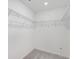 Walk-in closet with wire shelving and neutral walls at 4732 Babys Breath Pl, Kissimmee, FL 34758