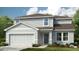 Charming two-story home with a two-car garage and well-manicured landscaping at 4732 Babys Breath Pl, Kissimmee, FL 34758
