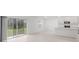 Bright living room with sliding glass doors and view into open kitchen at 4732 Babys Breath Pl, Kissimmee, FL 34758