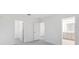 Bright main bedroom showing entry to the bathroom and closet, with neutral walls and carpet at 4732 Babys Breath Pl, Kissimmee, FL 34758