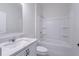 Clean bathroom featuring a shower-tub combo and white vanity with a light countertop at 16398 Yelloweyed Dr, Clermont, FL 34714