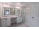 Bathroom featuring double vanity, lots of light, and tiled shower at 16398 Yelloweyed Dr, Clermont, FL 34714