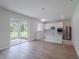 Bright kitchen featuring white cabinets, stainless steel appliances, and an open layout with patio access at 16398 Yelloweyed Dr, Clermont, FL 34714