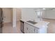 Kitchen with stainless steel appliances, island with sink, and access to pantry and living area at 16398 Yelloweyed Dr, Clermont, FL 34714