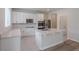 Modern kitchen with white cabinets, granite countertops, stainless steel appliances, and tile flooring at 16398 Yelloweyed Dr, Clermont, FL 34714