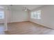 Large living room with hardwood floors, bright lighting, and multiple windows with backyard views at 16398 Yelloweyed Dr, Clermont, FL 34714