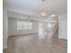 Bright and open living space featuring hardwood floors, modern lighting, and staircase access at 16398 Yelloweyed Dr, Clermont, FL 34714