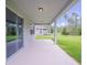 Large covered patio with a view of the backyard and wooded area at 16398 Yelloweyed Dr, Clermont, FL 34714