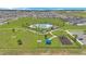 An aerial view showcases the community amenities including a pool, playground, and dog park at 2359 White Cedar Way, Haines City, FL 33844