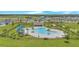 Aerial view of the community pool, playground, and green space for residents at 2359 White Cedar Way, Haines City, FL 33844