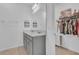 Elegant bathroom featuring a double sink vanity, a large mirror, and a walk-in closet at 2359 White Cedar Way, Haines City, FL 33844