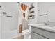 Well-lit bathroom with a modern vanity, white subway tile, and stylish shelving at 2359 White Cedar Way, Haines City, FL 33844