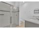 Modern bathroom featuring a glass-enclosed shower and sleek gray vanity with quartz countertop at 2359 White Cedar Way, Haines City, FL 33844
