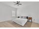 Bright bedroom featuring a ceiling fan, window, and wooden nightstands on each side of the bed at 2359 White Cedar Way, Haines City, FL 33844