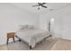 Clean and well-lit bedroom featuring modern wood flooring and a stylish ceiling fan at 2359 White Cedar Way, Haines City, FL 33844