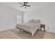 Serene bedroom with neutral tones, plush bedding, a ceiling fan, and simple decor creating a peaceful retreat at 2359 White Cedar Way, Haines City, FL 33844