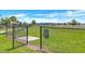 Community dog park with lush green grass and secure fencing for resident enjoyment at 2359 White Cedar Way, Haines City, FL 33844