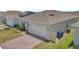 Nice home featuring an attached garage, brick driveway, and low-maintenance landscaping at 2359 White Cedar Way, Haines City, FL 33844