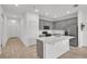 Open-concept kitchen featuring gray cabinetry, stainless steel appliances, and a center island at 2359 White Cedar Way, Haines City, FL 33844