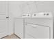 Convenient laundry room equipped with a modern white washer and dryer at 2359 White Cedar Way, Haines City, FL 33844