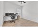 Well-lit office space with wood-look floors, a desk setup, and a ceiling fan at 2359 White Cedar Way, Haines City, FL 33844