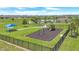 Aerial view of a neighborhood park featuring a playground and manicured green space at 2359 White Cedar Way, Haines City, FL 33844