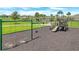 Neighborhood playground with swings and climbing structure in a green space at 2359 White Cedar Way, Haines City, FL 33844