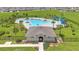 Aerial view of the community pool with clubhouse and lounge area at 2359 White Cedar Way, Haines City, FL 33844