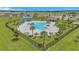 Aerial view of a community pool area with palm trees and a splash pad at 2359 White Cedar Way, Haines City, FL 33844