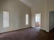 Cozy bedroom with neutral paint, two windows, and plush carpeting, plus an ensuite bathroom for added privacy at 103 Thornbush Pkwy, Davenport, FL 33837