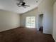 Spacious bedroom with high ceilings, sliding doors, a ceiling fan, and a doorway to an adjacent room at 103 Thornbush Pkwy, Davenport, FL 33837