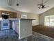 Open-concept kitchen featuring appliances, tile backsplash, and an adjacent living area, offering seamless entertaining at 103 Thornbush Pkwy, Davenport, FL 33837