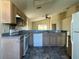 Functional kitchen with appliances, wood cabinets, and an open layout offering an efficient cooking and living space at 103 Thornbush Pkwy, Davenport, FL 33837