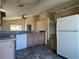 Simple kitchen layout with appliances and ample cabinet space, adjacent to a well-lit dining and living area at 103 Thornbush Pkwy, Davenport, FL 33837