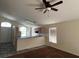 Open concept living room with breakfast bar, neutral walls, ceiling fan and window at 103 Thornbush Pkwy, Davenport, FL 33837