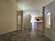Open-concept living room with decorative tile flooring, leading to kitchen area at 103 Thornbush Pkwy, Davenport, FL 33837