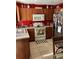 Functional kitchen with ample counter space, modern appliances, and warm wood cabinetry at 110 N Chester St, Leesburg, FL 34748