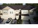 Aerial view of beige two-story townhomes with brown roofs and two-car garages at 1634 Plumeria Pl, Oviedo, FL 32765