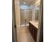 Well-lit bathroom with double sinks, updated fixtures, and a glass-enclosed shower at 1634 Plumeria Pl, Oviedo, FL 32765