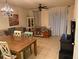Open-concept living room with tile floors, chandelier, ceiling fan, and staircase at 1634 Plumeria Pl, Oviedo, FL 32765