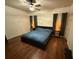Main bedroom with wood floors, a ceiling fan, and neutral-colored walls at 1634 Plumeria Pl, Oviedo, FL 32765