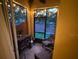 Screened patio with string lights, chairs, grill, and brick wall at 1634 Plumeria Pl, Oviedo, FL 32765