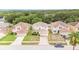 Aerial view of a suburban neighborhood featuring two-story homes, driveways, and green spaces at 16828 N Gold Star Ct, Clermont, FL 34714