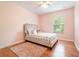 Cozy bedroom with hardwood floors and a window at 16828 N Gold Star Ct, Clermont, FL 34714