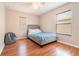Bright bedroom with hardwood floors, two windows, and bean bag chair at 16828 N Gold Star Ct, Clermont, FL 34714