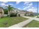 Charming two-story home with a well-maintained lawn and a two-car garage in a quiet neighborhood at 16828 N Gold Star Ct, Clermont, FL 34714