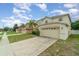 Charming two-story home with a well-maintained lawn and a two-car garage in a quiet neighborhood at 16828 N Gold Star Ct, Clermont, FL 34714