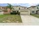 Inviting two-story home with a lush lawn and two-car garage, perfect for suburban living at 16828 N Gold Star Ct, Clermont, FL 34714