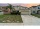 Inviting two-story home with a lush lawn and two-car garage, perfect for suburban living at 16828 N Gold Star Ct, Clermont, FL 34714